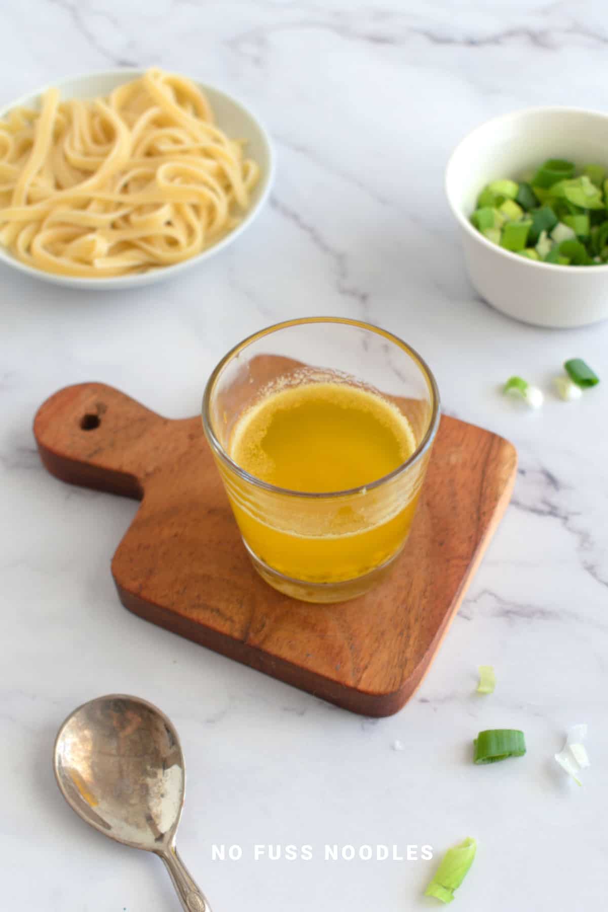 Garlic butter sauce on a wooden board.