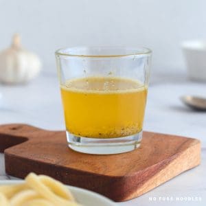 Garlic butter sauce in a glass.