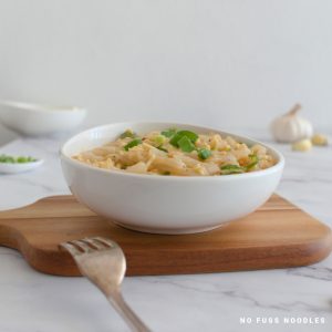 Hot garlic noodles in a white bowl.