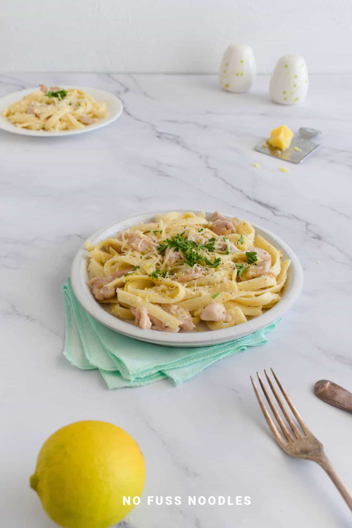 Garlic butter noodles with chicken in a plate.