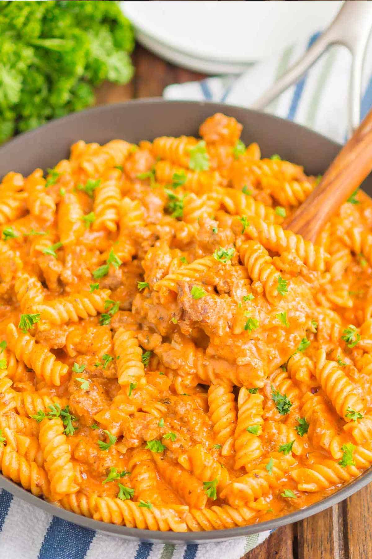 Close up image of pasta in a grey bowl.