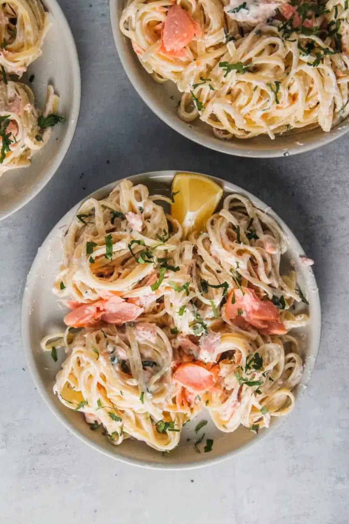 Salmon pasta in a grey plate.