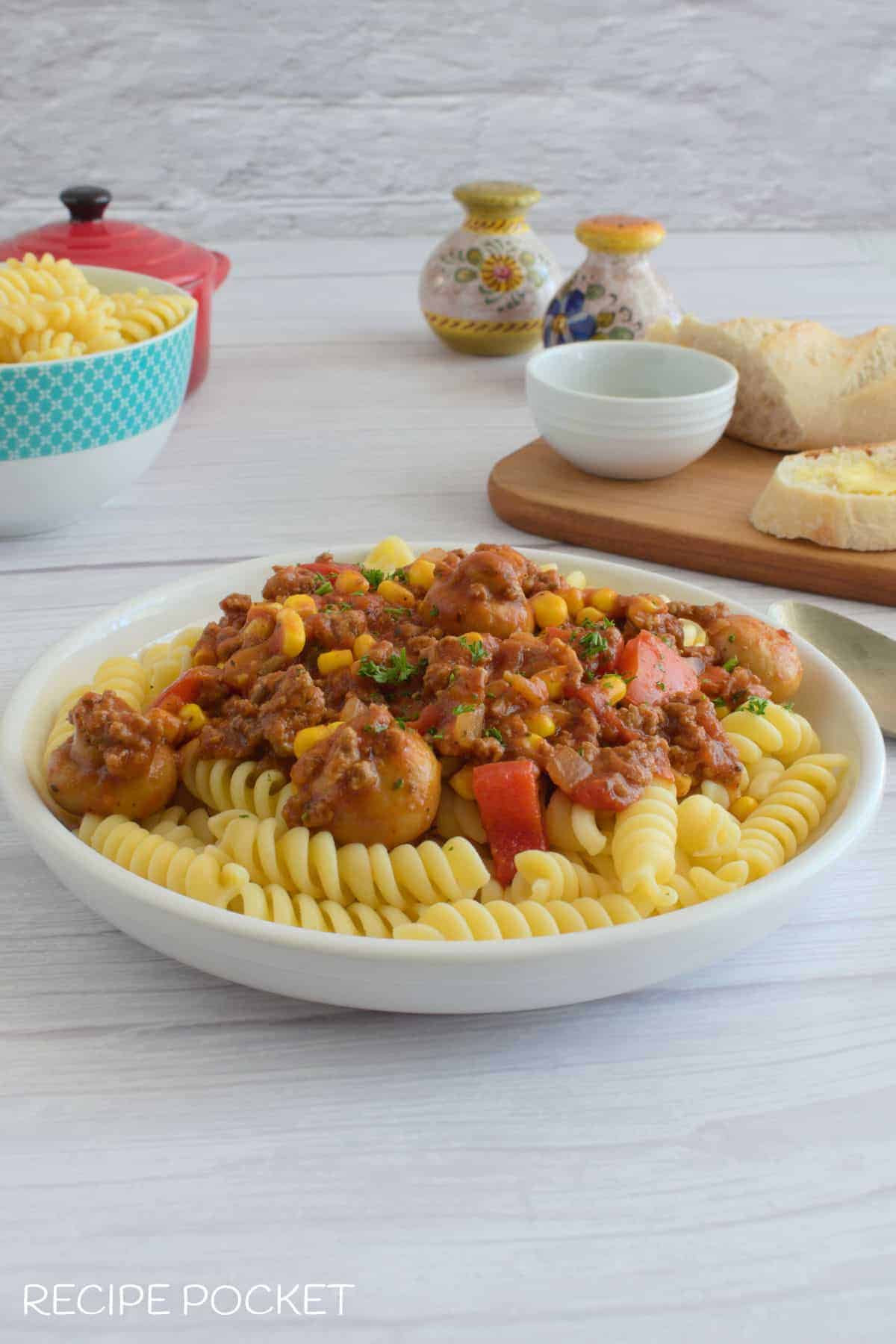 Crockpot goulash in a bowl with pasta.