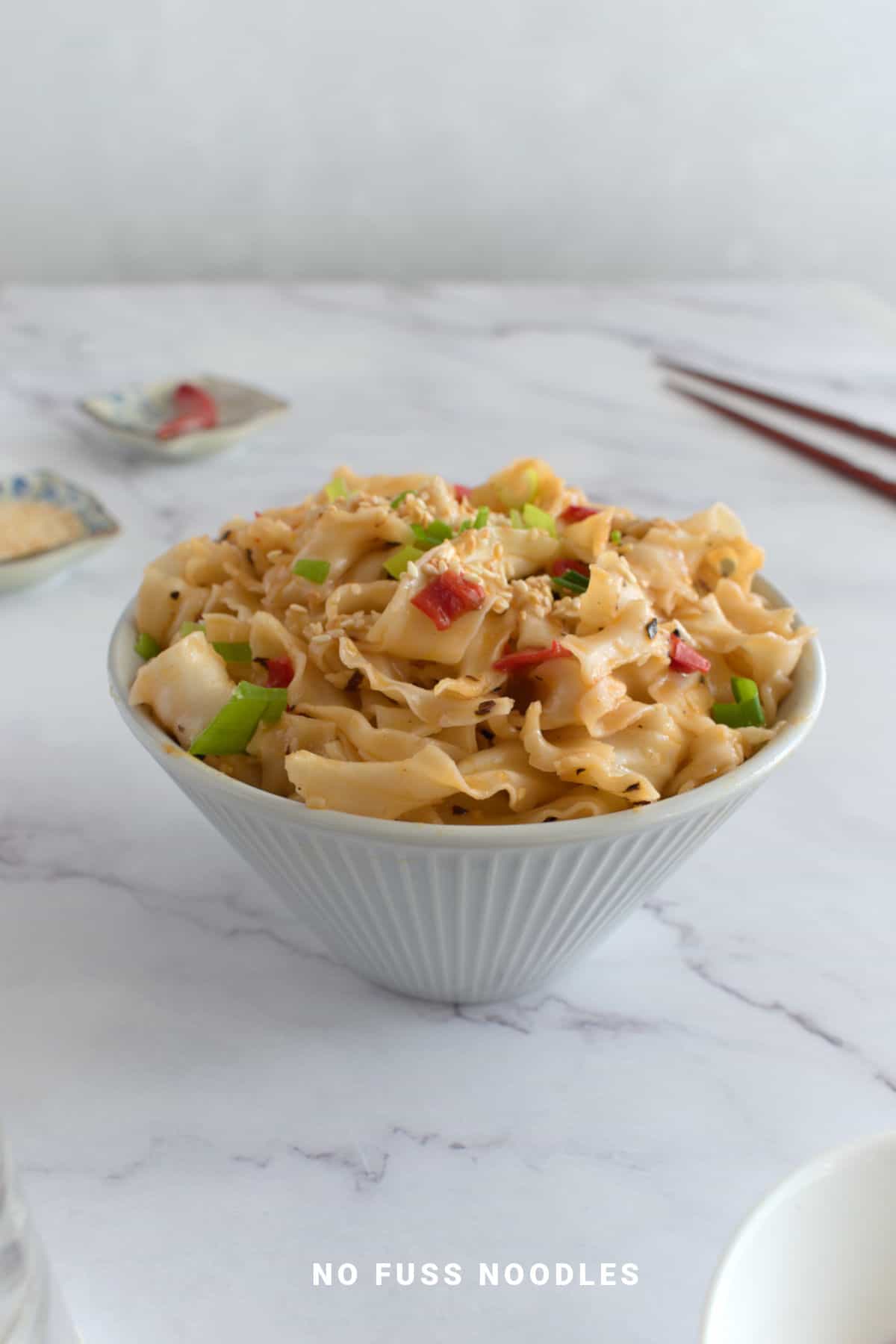Close up image of chili oil garlic noodles in a bowl.