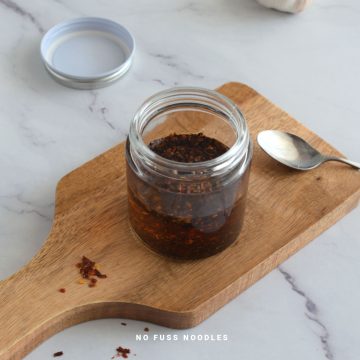 Chili oil in a glass jar.