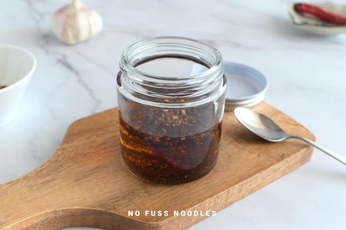 Close up image of chili oil in a jar.