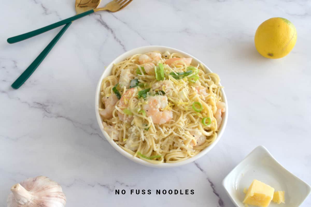 Close up image of garlic shrimp pasta in a bowl.