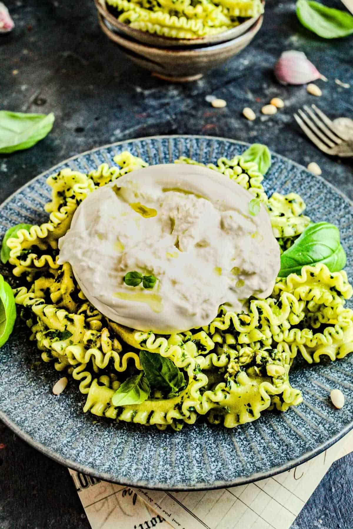 Pesto pasta in a blue plate.