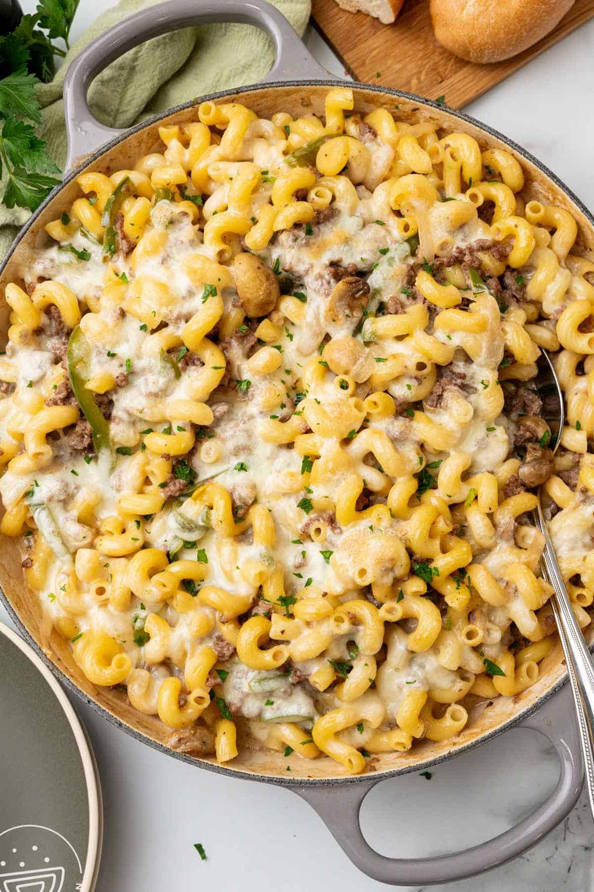 Philly cheesesteak pasta in a saucepan.