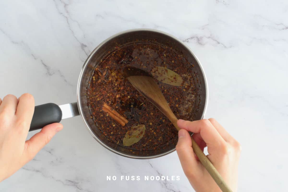 Cooking chili garlic oil in a saucepan.
