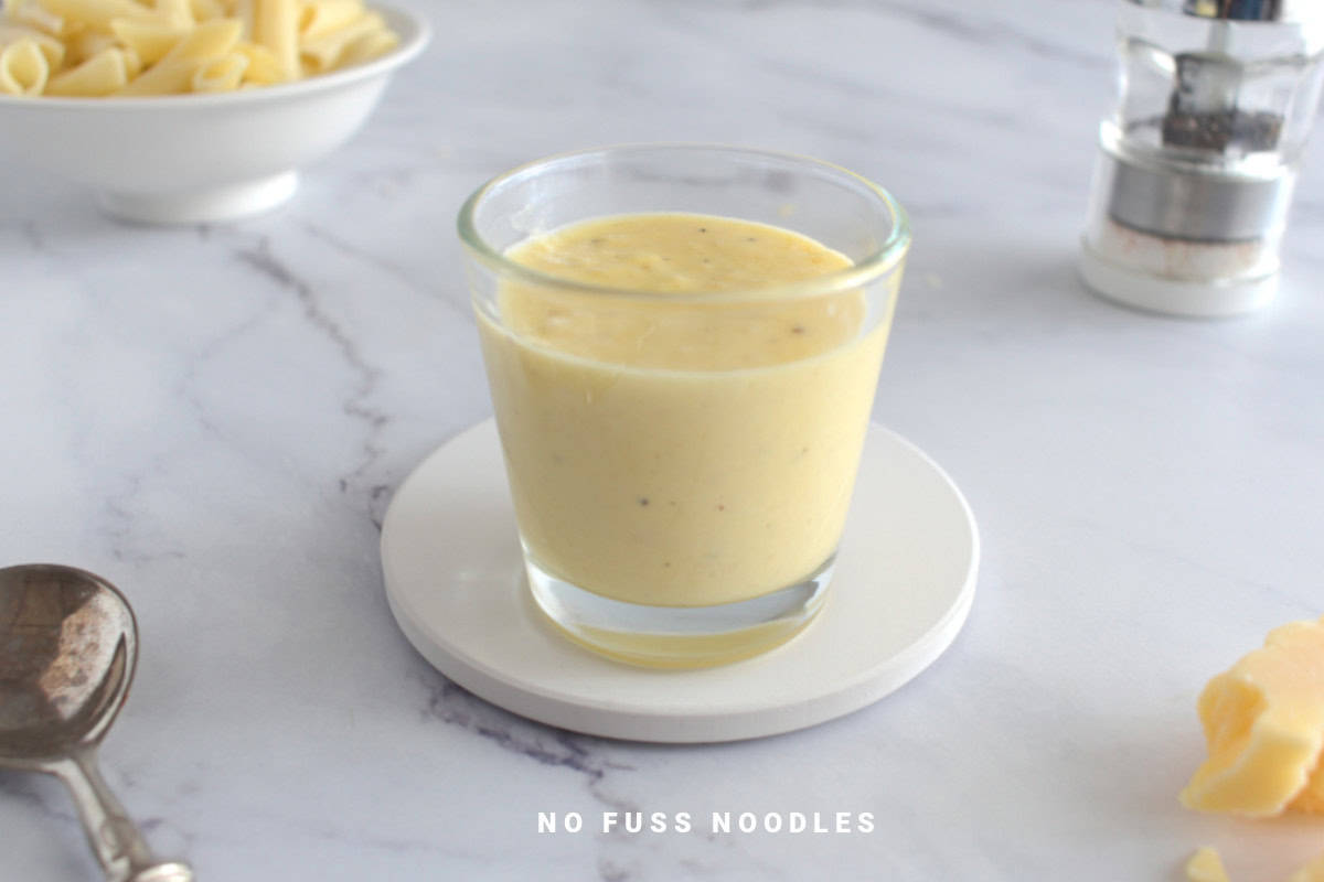 Alfredo sauce in a glass.