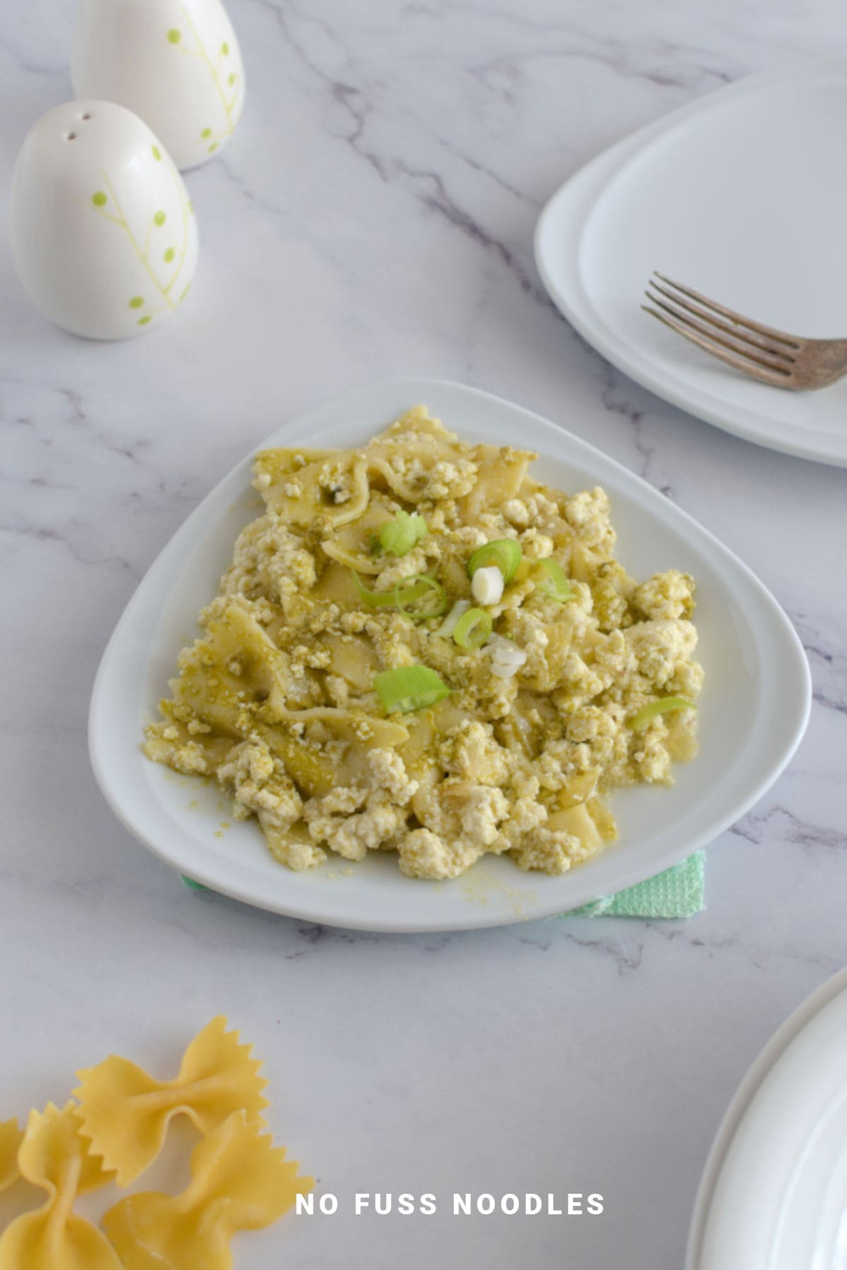 Pesto pasta in a triangle shaped plate.
